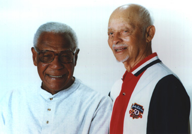 Two older men standing next to each other.