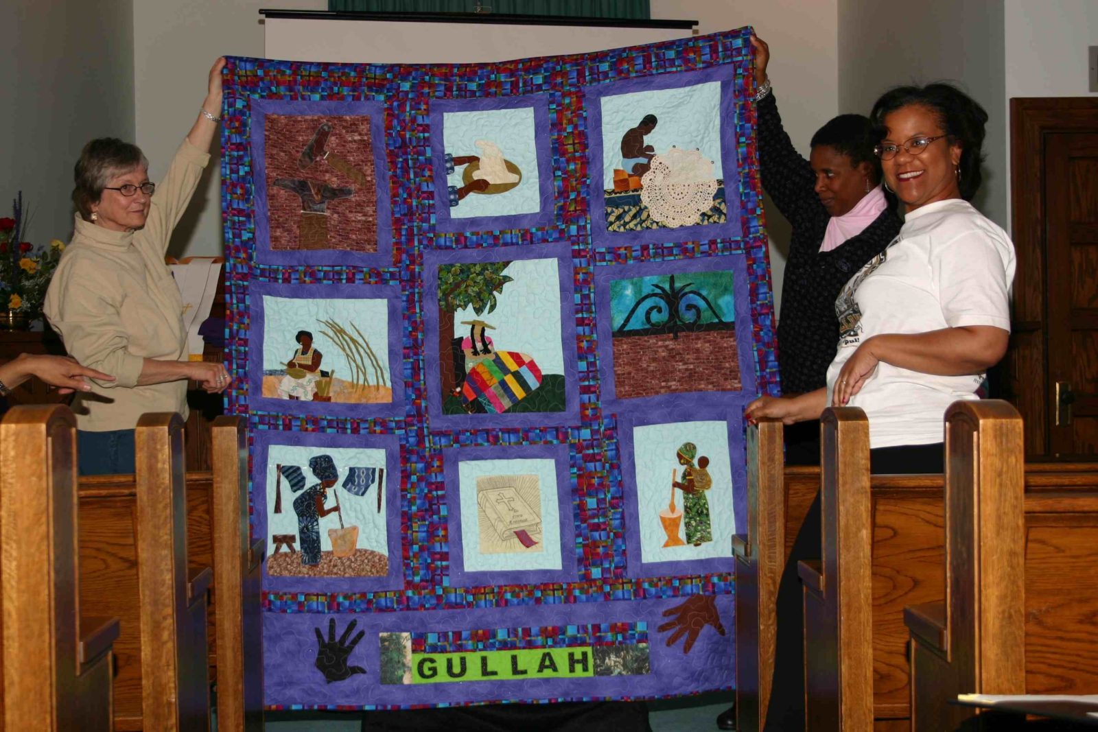 A quilt with pictures of people and names on it.