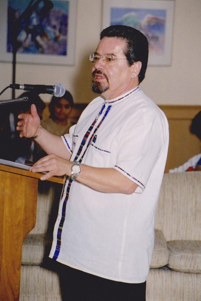 A man standing at a podium in front of a microphone.