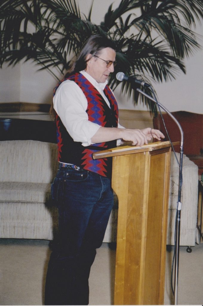 A man standing at the podium in front of a microphone.