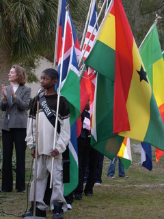 A group of people standing around with flags.