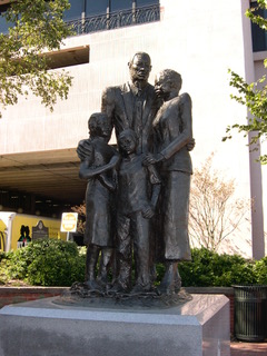 A statue of three people standing next to each other.