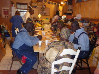 A group of people sitting at a table eating.