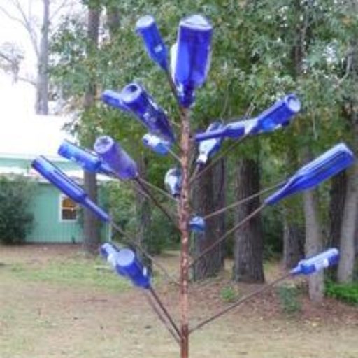 A tree with many blue bottles on it